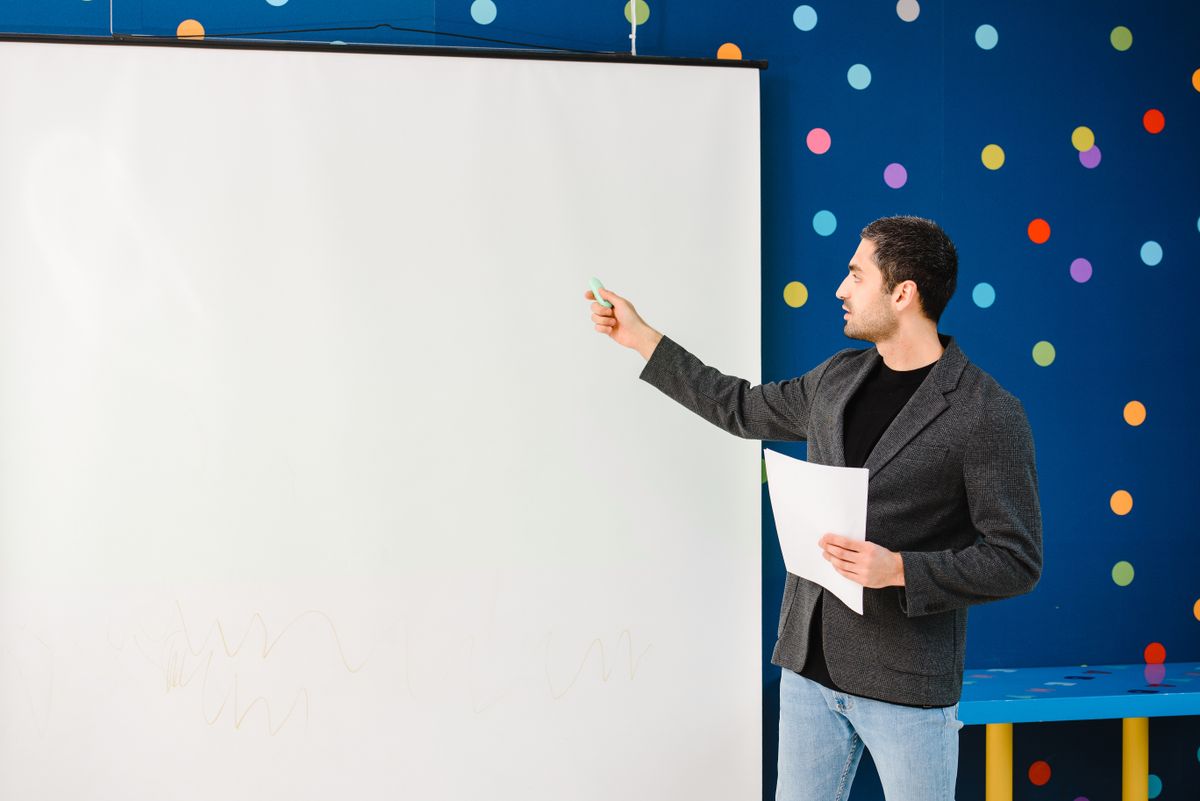 Illustrative photograph of a teacher using a classroom screen